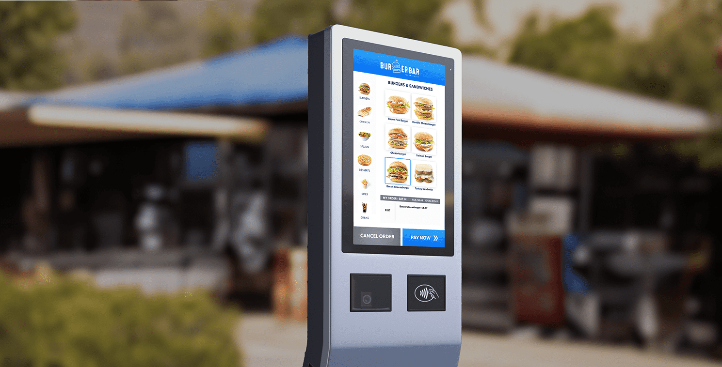 AI-Enabled Self-Service Kiosk at Quick Service Restaurant Outdoor touchscreen kiosk displaying a digital menu for a burger restaurant, showcasing AI-driven drive-through ordering technology in a QSR environment.